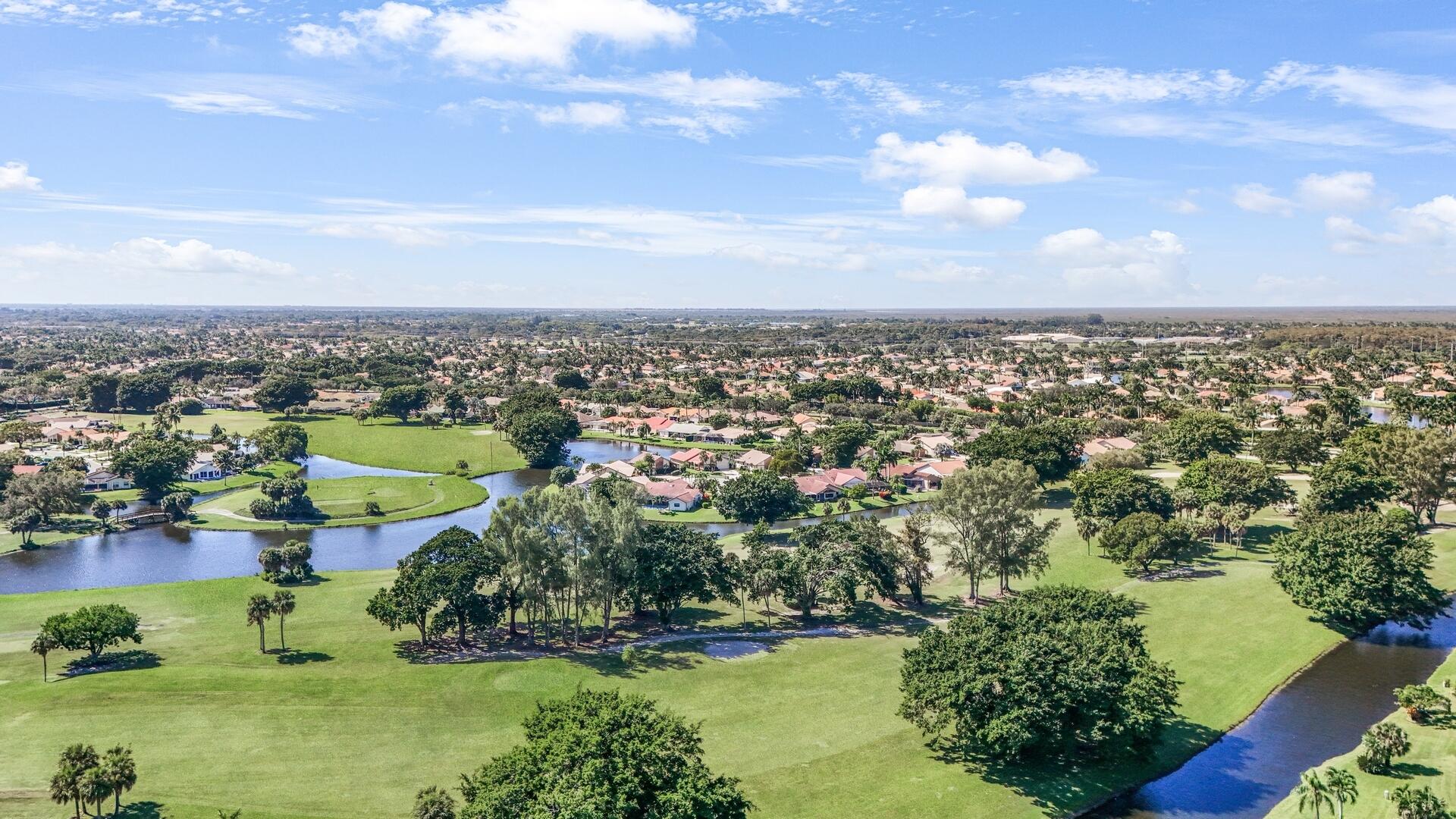 19261 Cherry Hills Terrace Boca Raton, FL 33498 - Photo 49 of 53 an aerial view of a city with lots of residential buildings ocean and mountain view in back