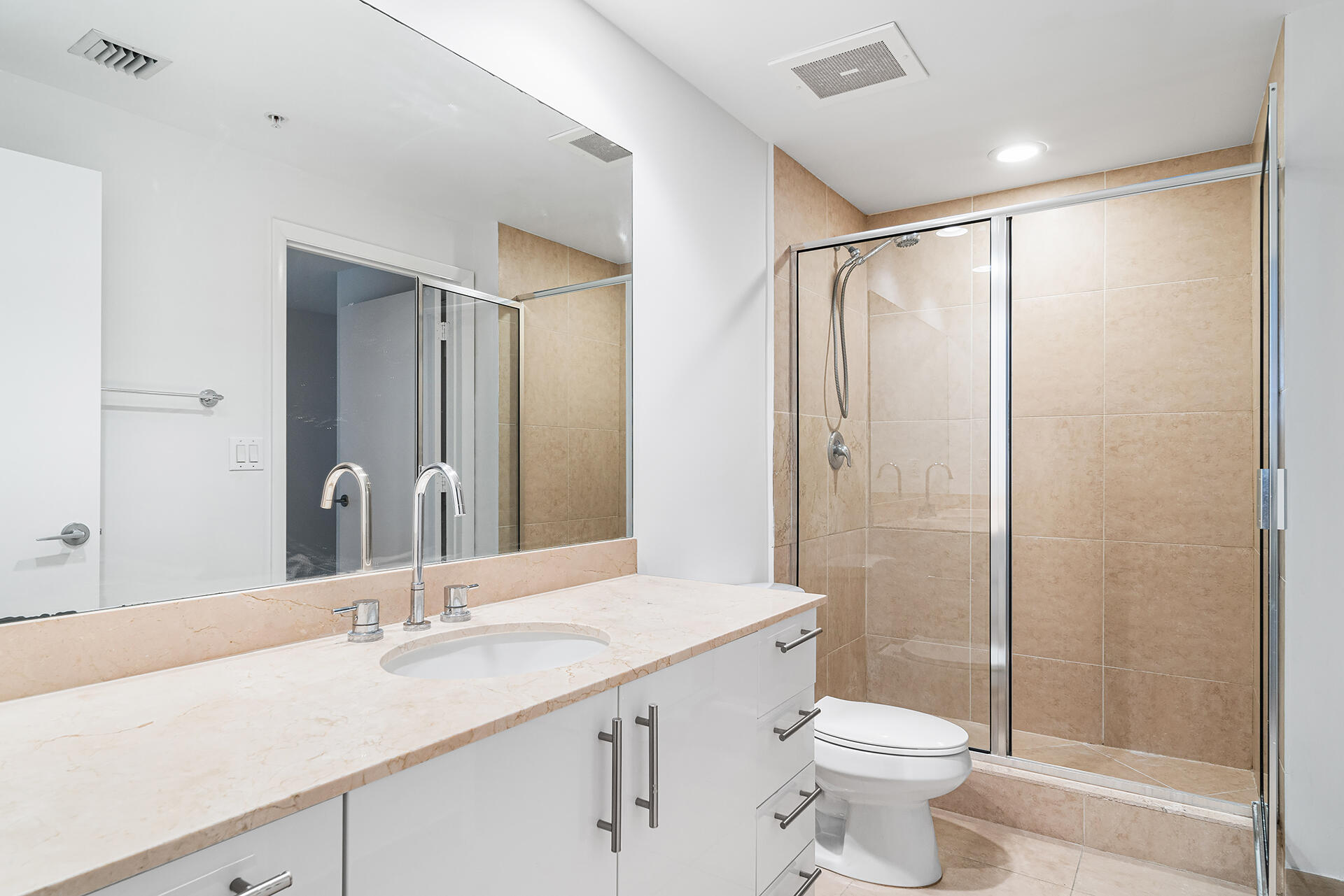 550 Okeechobee Boulevard, Unit 428 West Palm Beach, FL 33401 - Photo 19 of 29 a bathroom with a double vanity sink toilet and shower