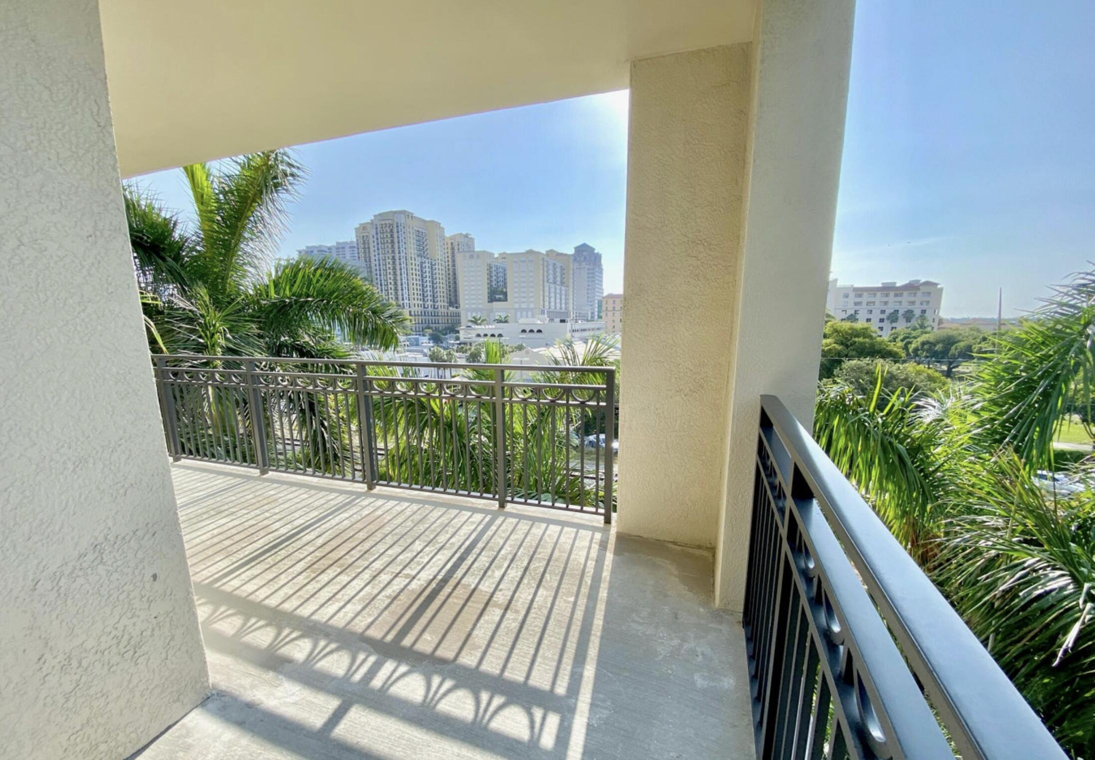 550 Okeechobee Boulevard, Unit 428 West Palm Beach, FL 33401 - Photo 22 of 29 a balcony with view of lake view and a floor to ceiling window