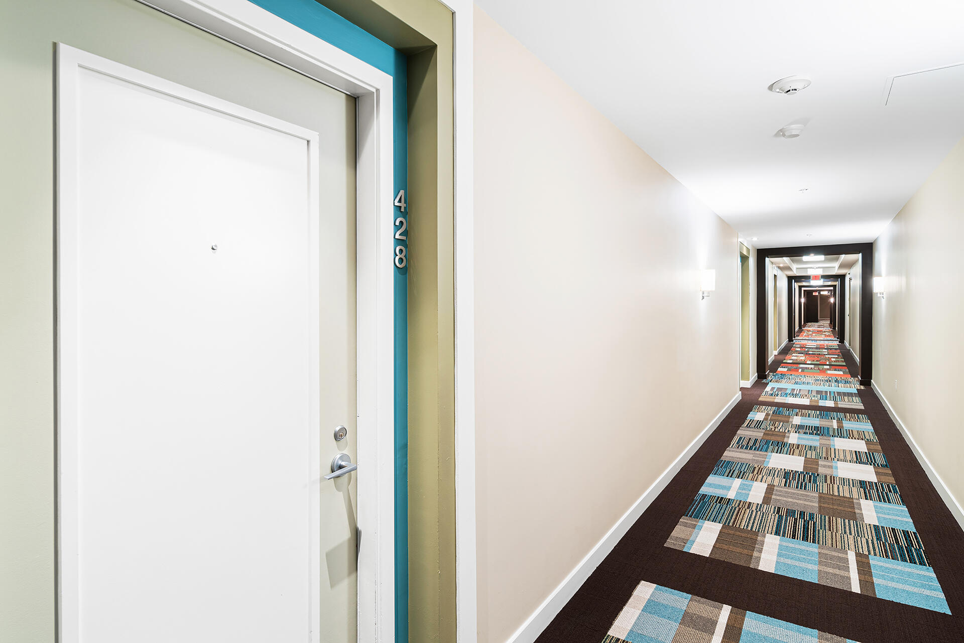 550 Okeechobee Boulevard, Unit 428 West Palm Beach, FL 33401 - Photo 23 of 29 a view of a hallway with wooden floor and staircase