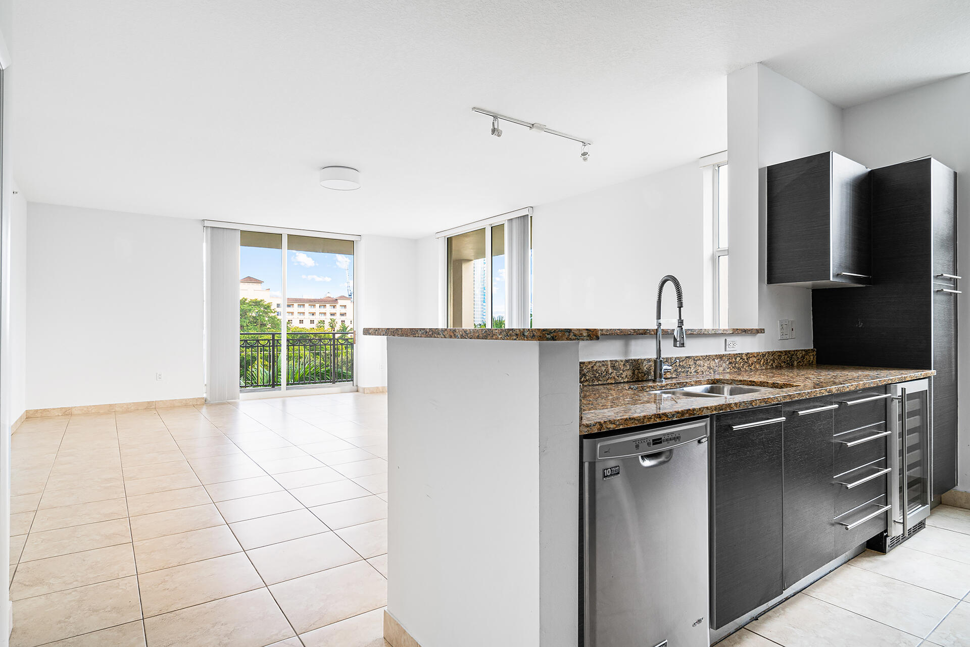 550 Okeechobee Boulevard, Unit 428 West Palm Beach, FL 33401 - Photo 6 of 29 a kitchen with stainless steel appliances a sink stove and refrigerator