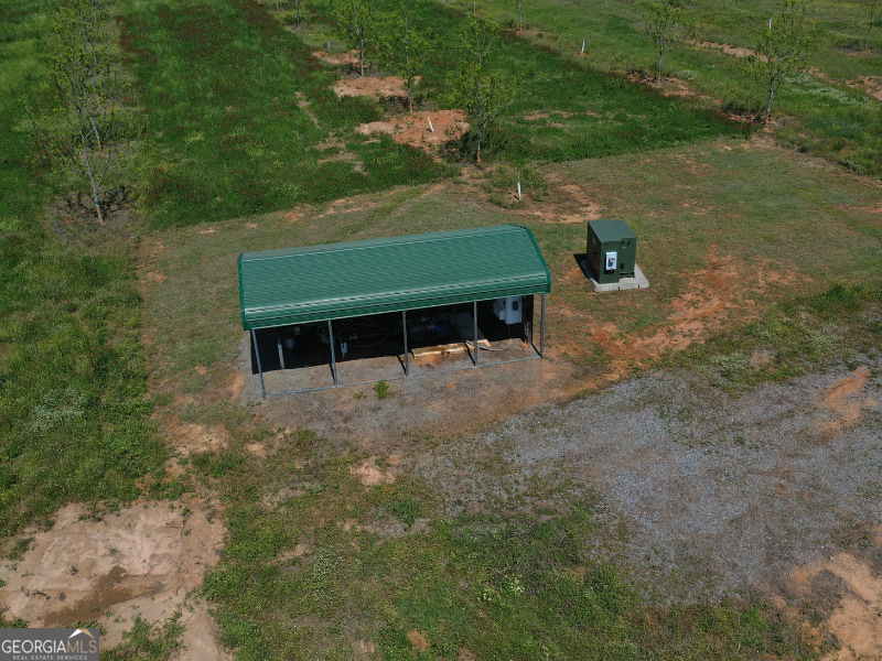 302 East Flournoy Road Hawkinsville, GA 31036 - Photo 12 of 20 a view of a two chairs in a backyard