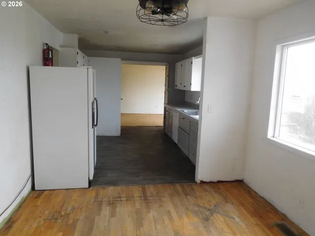 a view of a kitchen with a refrigerator a stove top oven and a refrigerator