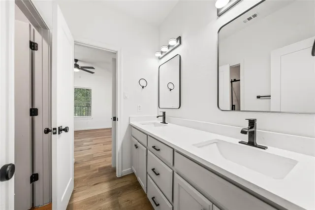 a bathroom with a double vanity sink mirror and double