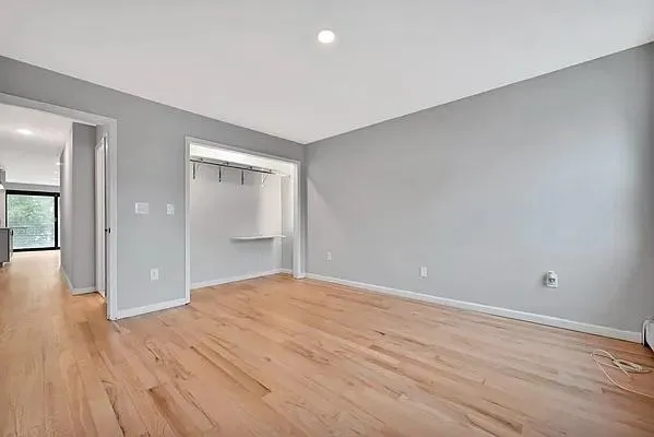wooden floor in an empty room with a window