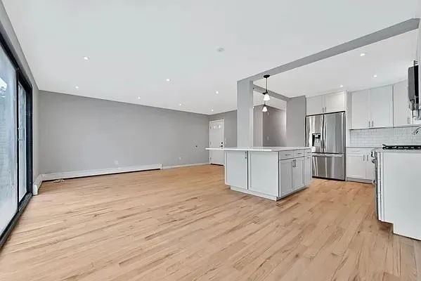 a view of a kitchen with wooden floor