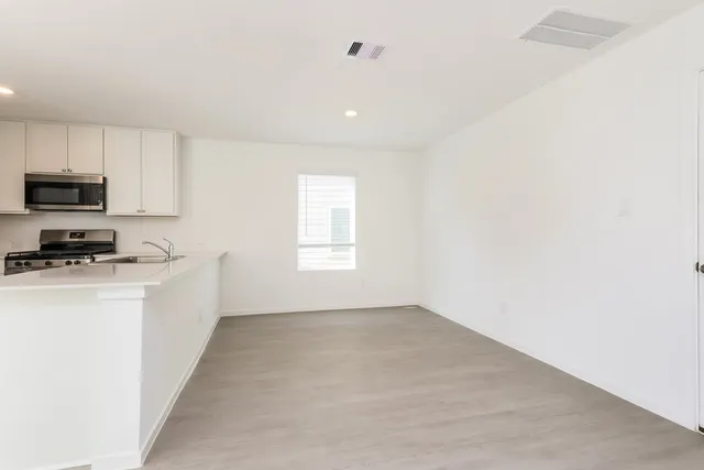 a kitchen with stainless steel appliances a stove sink and refrigerator