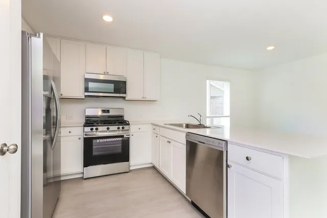a view of kitchen sink and refrigerator