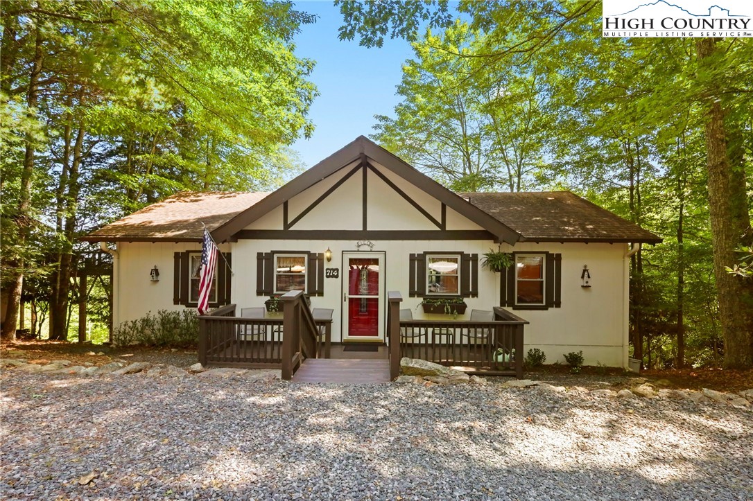 714 Pine Ridge Road Beech Mountain, NC 28604 - Photo 1 of 27 a view of a house with a yard and large tree