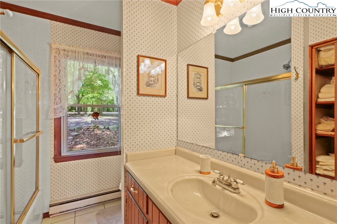 714 Pine Ridge Road Beech Mountain, NC 28604 - Photo 15 of 27 a bathroom with 2 sink and a mirror