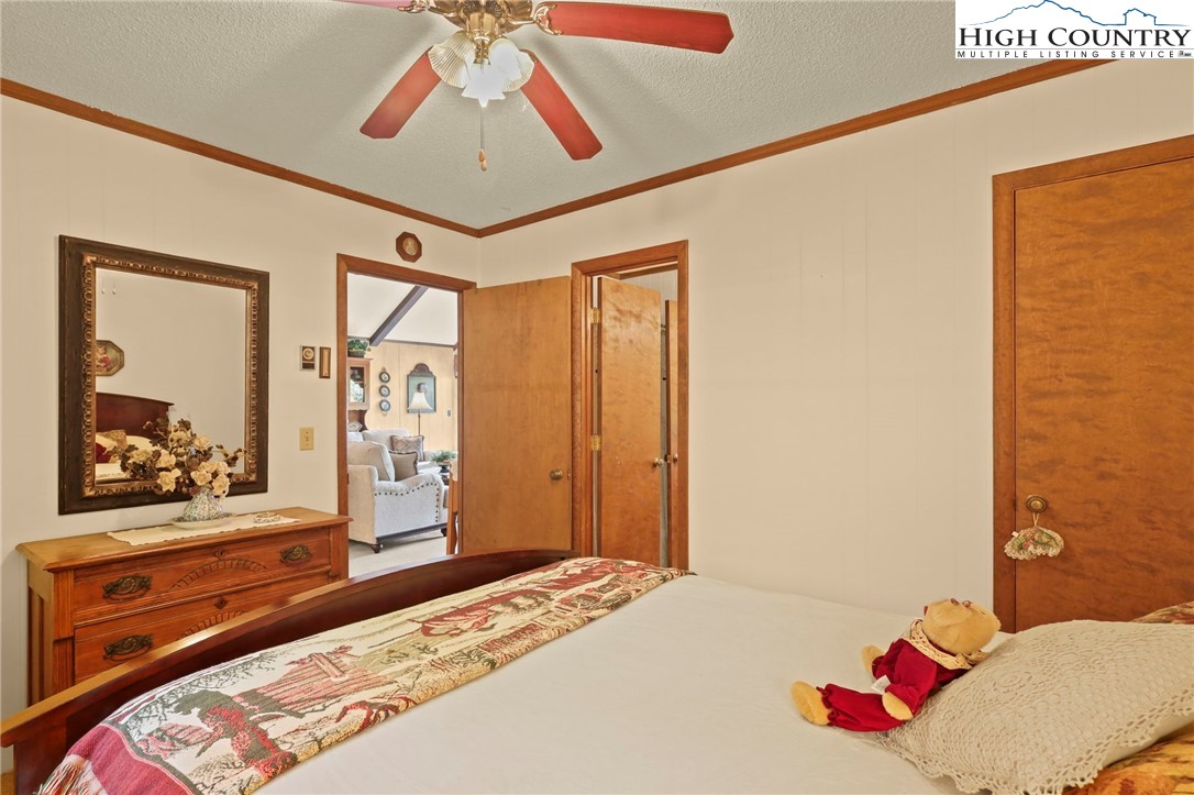 714 Pine Ridge Road Beech Mountain, NC 28604 - Photo 19 of 27 a bedroom with a bed and a dresser