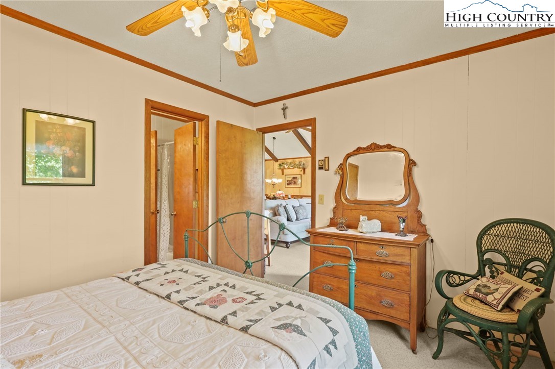 714 Pine Ridge Road Beech Mountain, NC 28604 - Photo 23 of 27 a bedroom with a bed and dresser with mirror