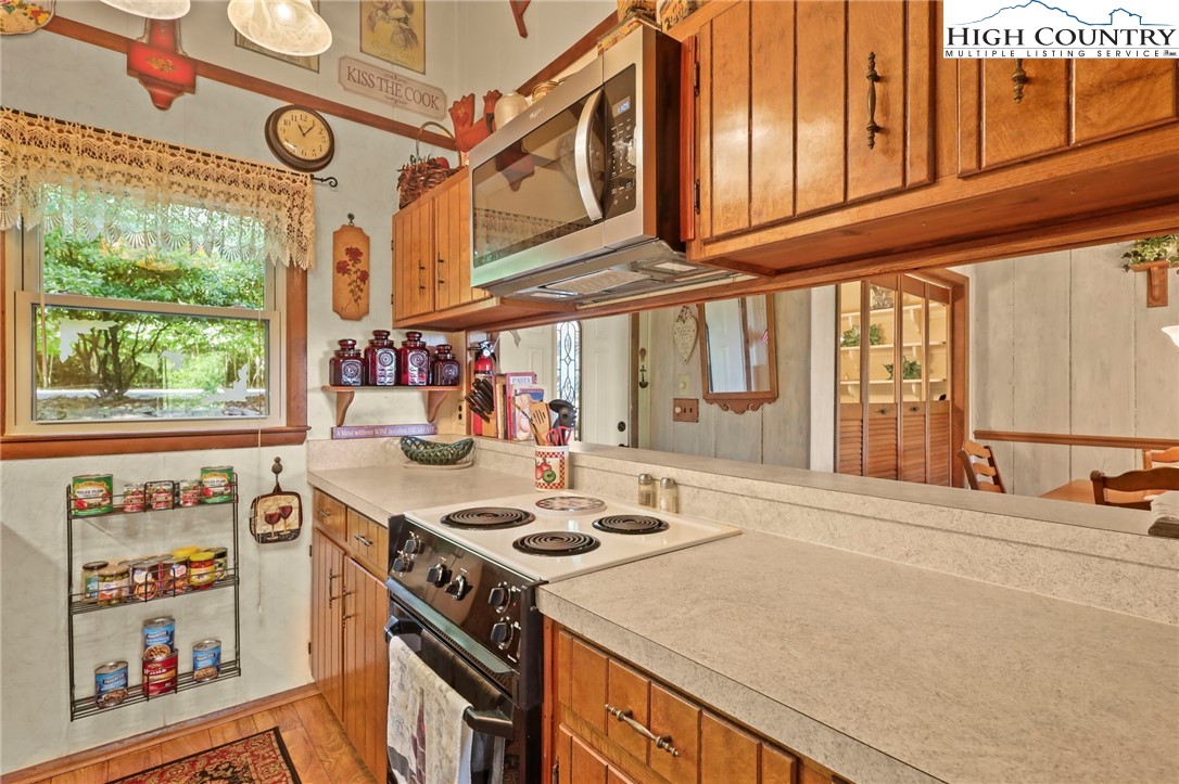 714 Pine Ridge Road Beech Mountain, NC 28604 - Photo 7 of 27 a kitchen with stainless steel appliances granite countertop a stove and a sink with cabinets