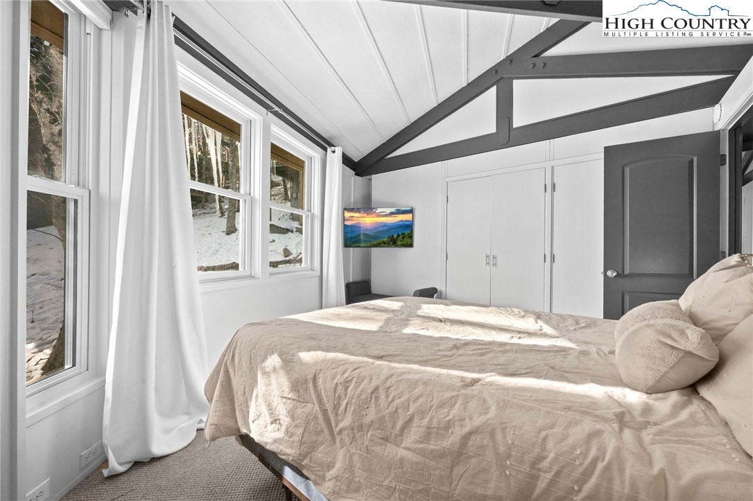 109 Skiloft Road Beech Mountain, NC 28604 - Photo 16 of 30 a bedroom with a bed and a large window