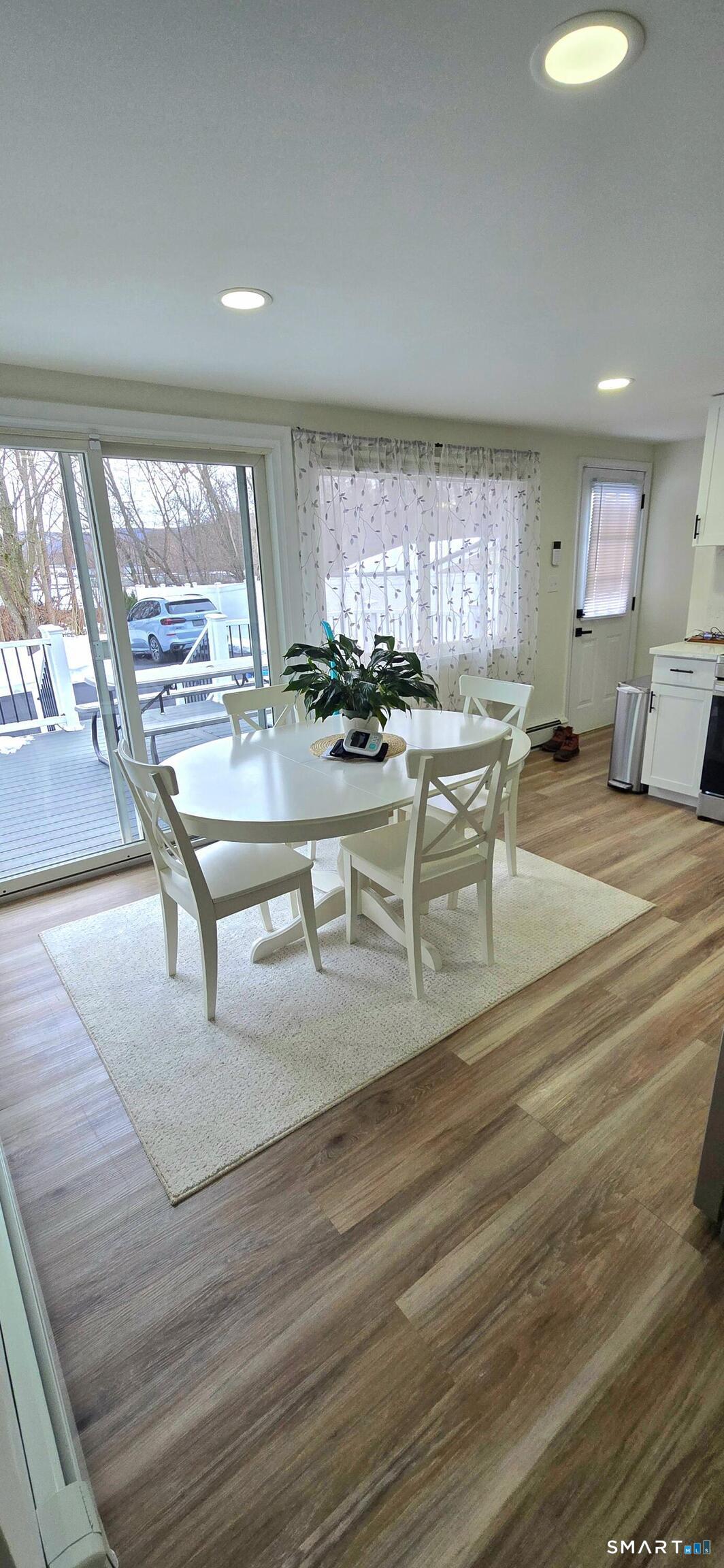 64 4th Street Bristol, CT 06010 - Photo 11 of 44 a room with lots of table chair and a large window