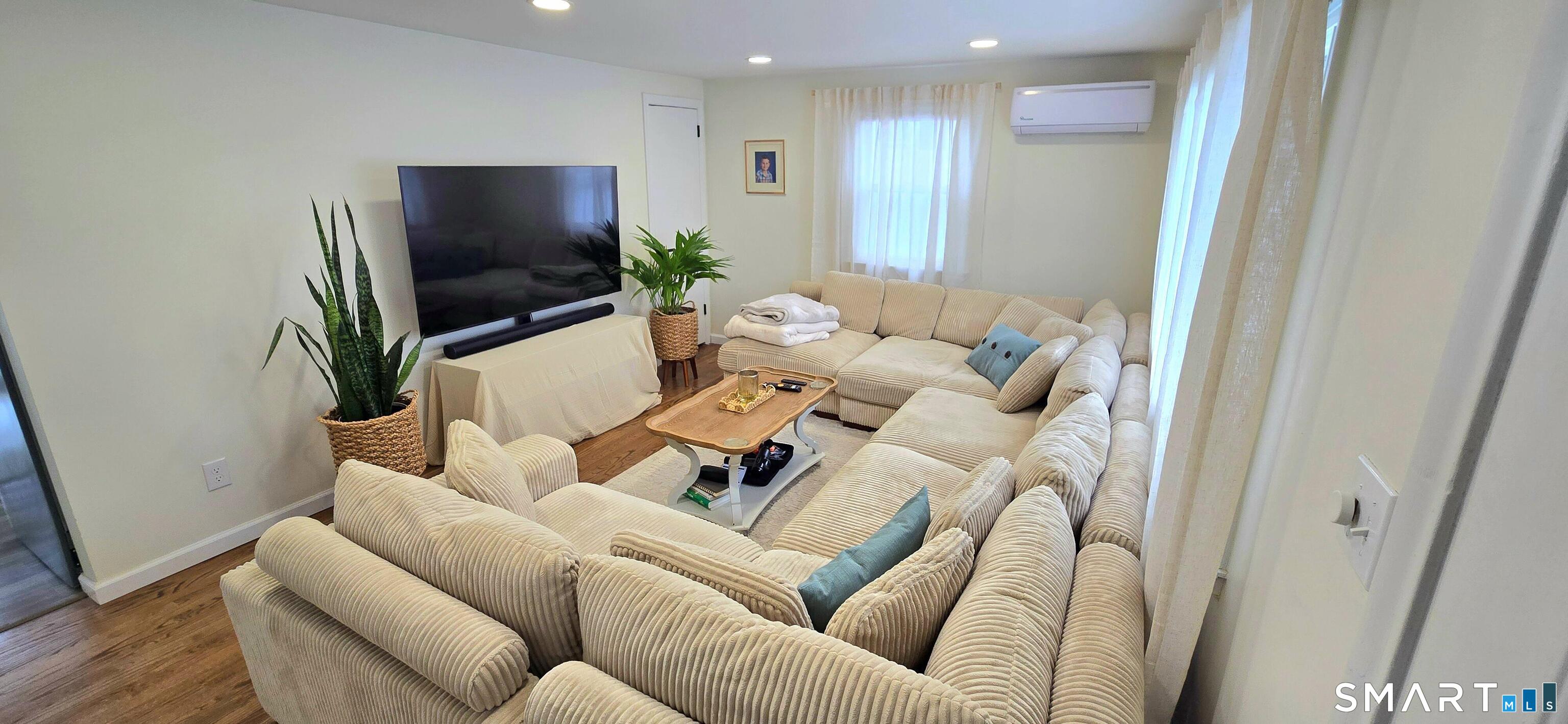 64 4th Street Bristol, CT 06010 - Photo 16 of 44 a living room with furniture and a flat screen tv