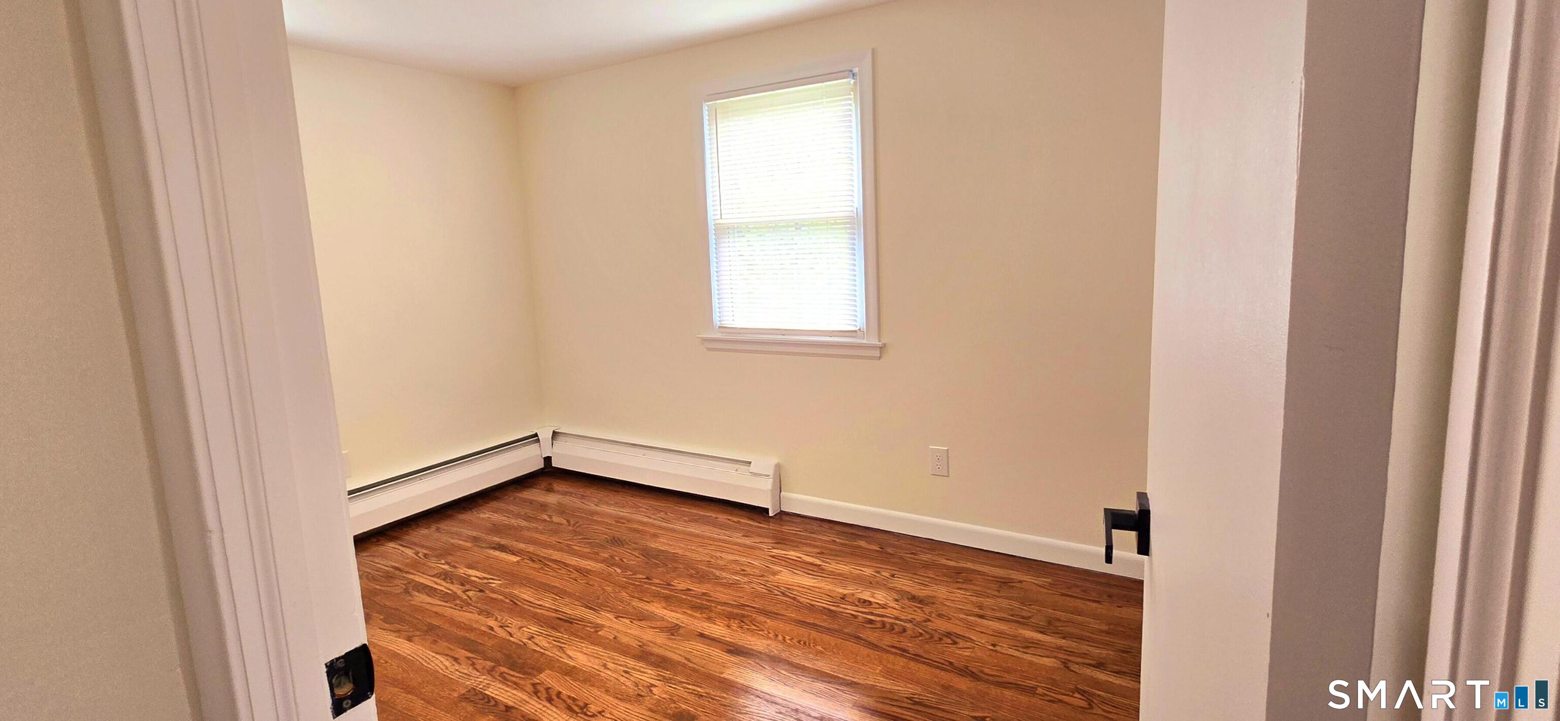 64 4th Street Bristol, CT 06010 - Photo 19 of 44 a view of empty room with wooden floor