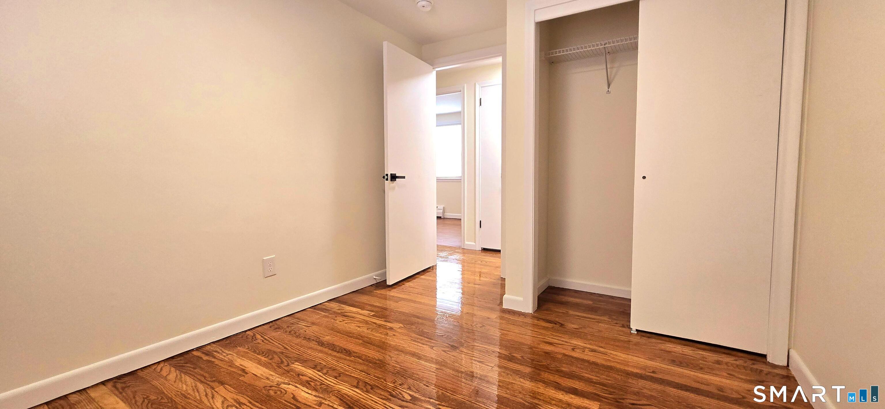 64 4th Street Bristol, CT 06010 - Photo 21 of 44 a view of an empty room with wooden floor and a window