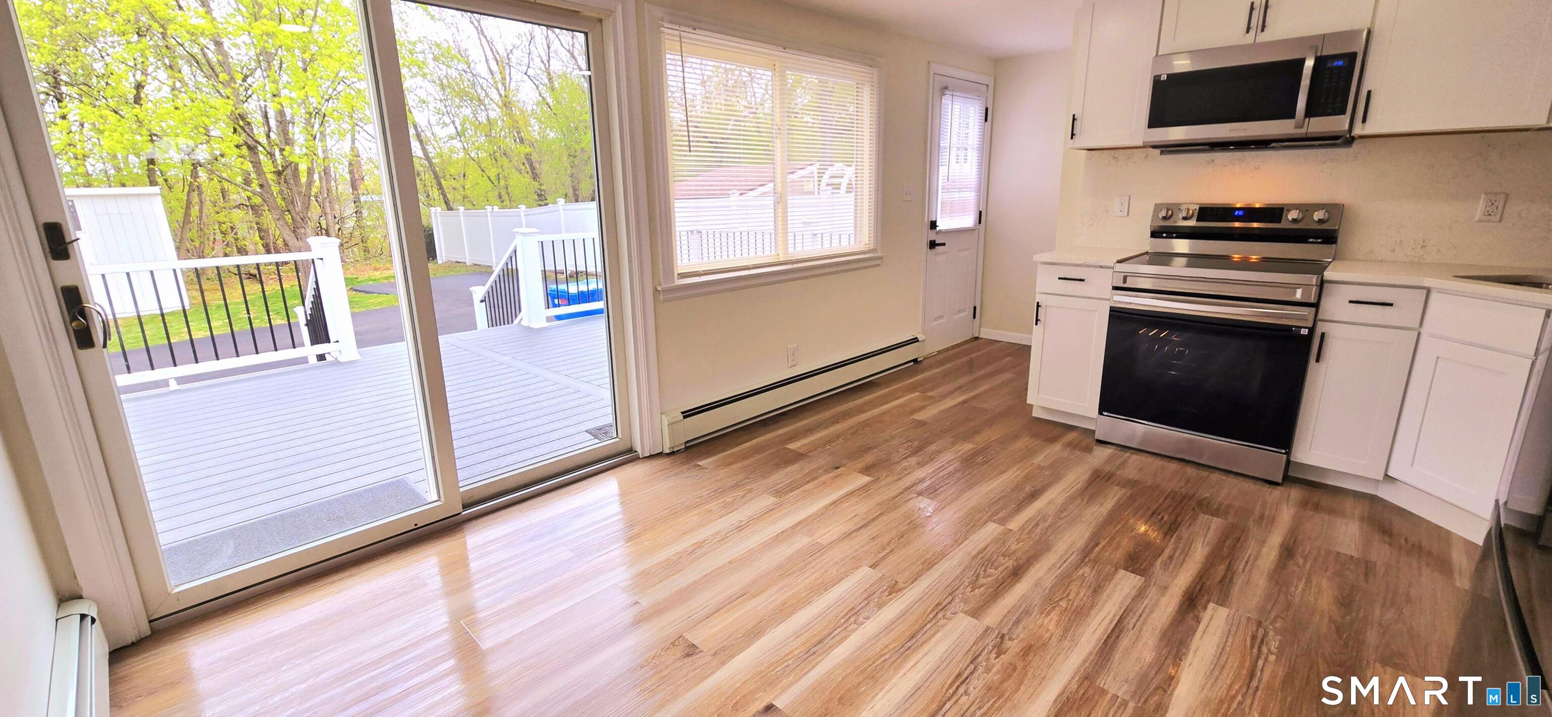 64 4th Street Bristol, CT 06010 - Photo 5 of 44 a kitchen with a stove a sink and a microwave