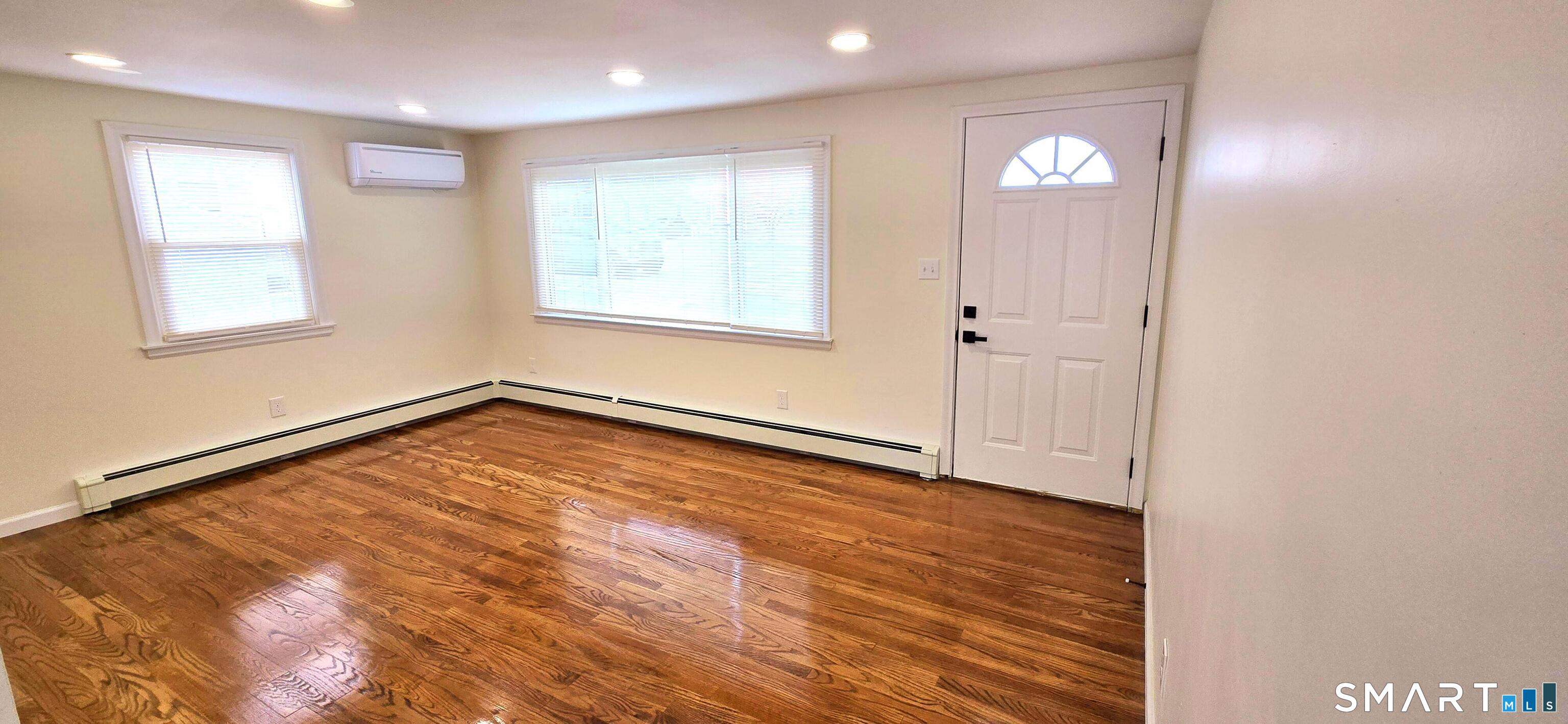 64 4th Street Bristol, CT 06010 - Photo 7 of 44 wooden floor in an empty room with a window