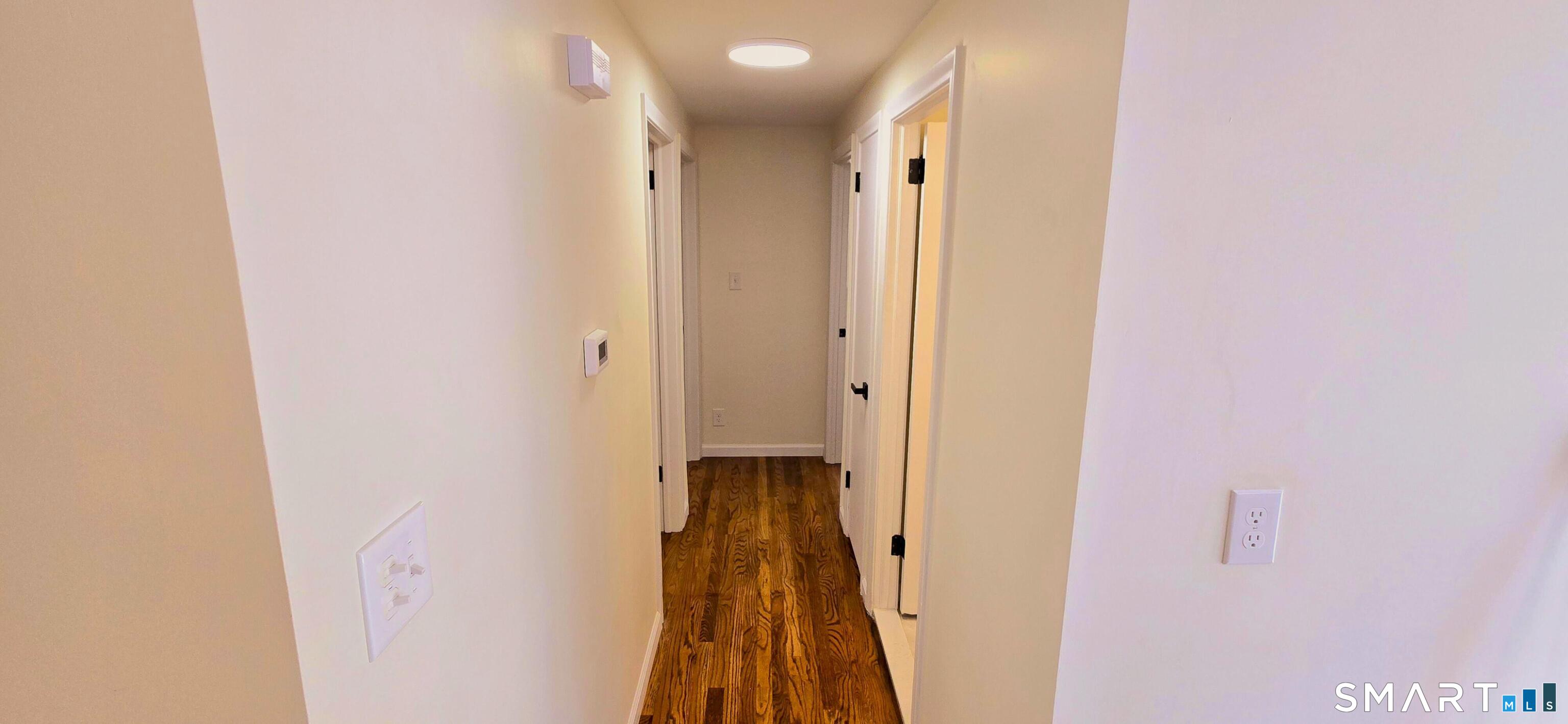 64 4th Street Bristol, CT 06010 - Photo 10 of 44 a view of a hallway with wooden floor