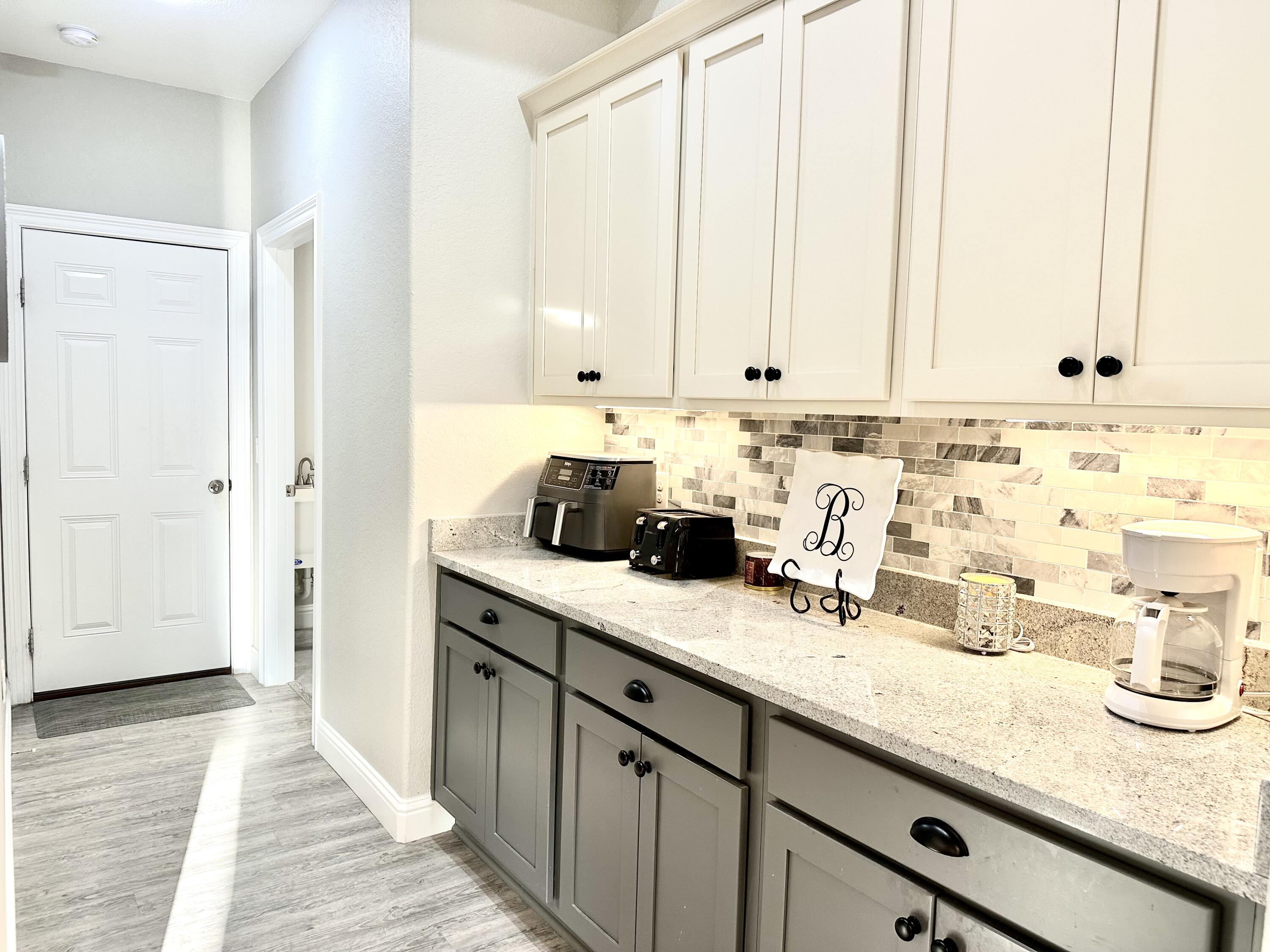 1207 Tallokas Road Crestview, FL 32536 - Photo 25 of 58 a kitchen with stainless steel appliances a sink a window and white cabinets