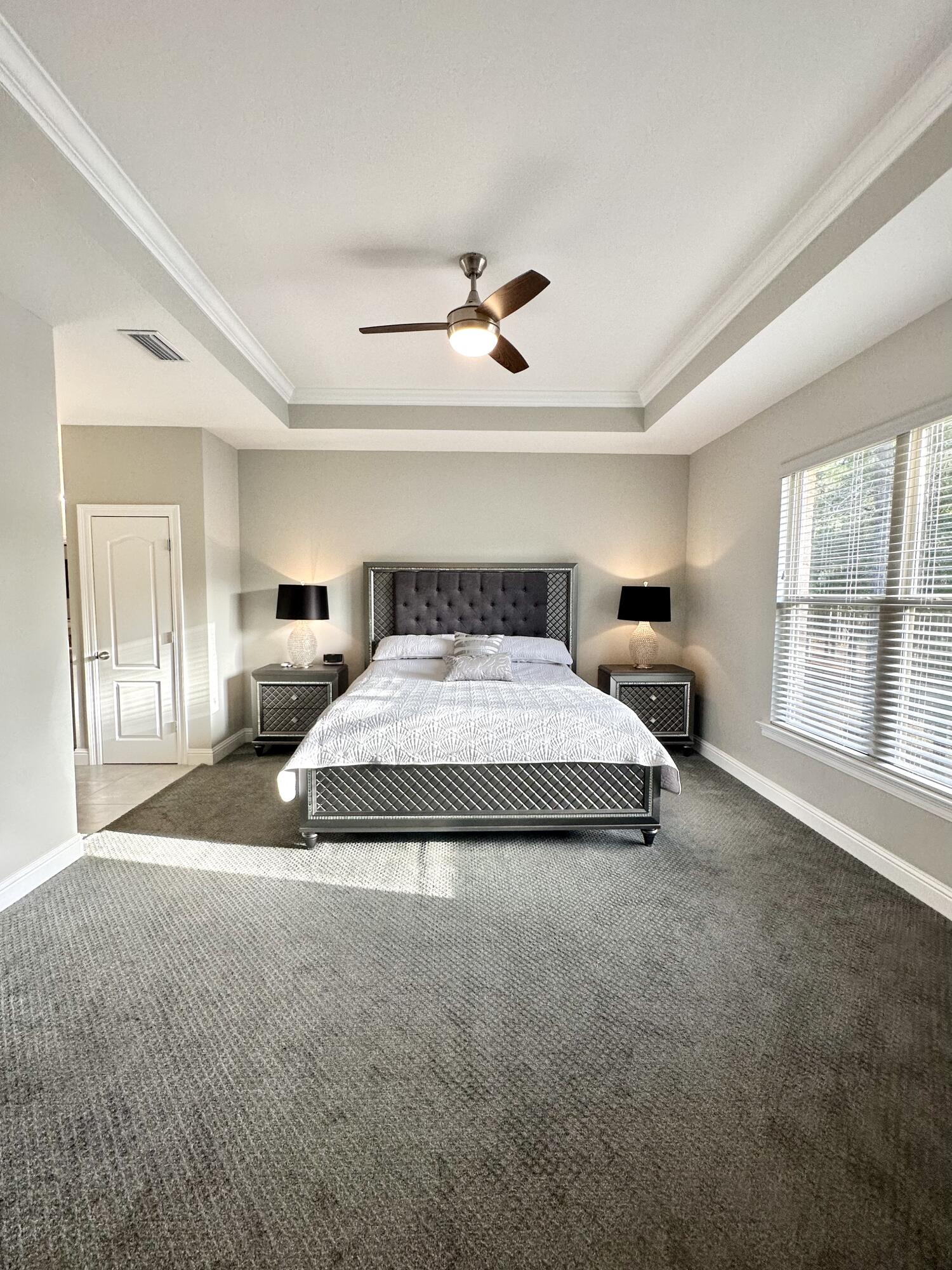 1207 Tallokas Road Crestview, FL 32536 - Photo 26 of 58 a spacious bedroom with a large bed and a large window