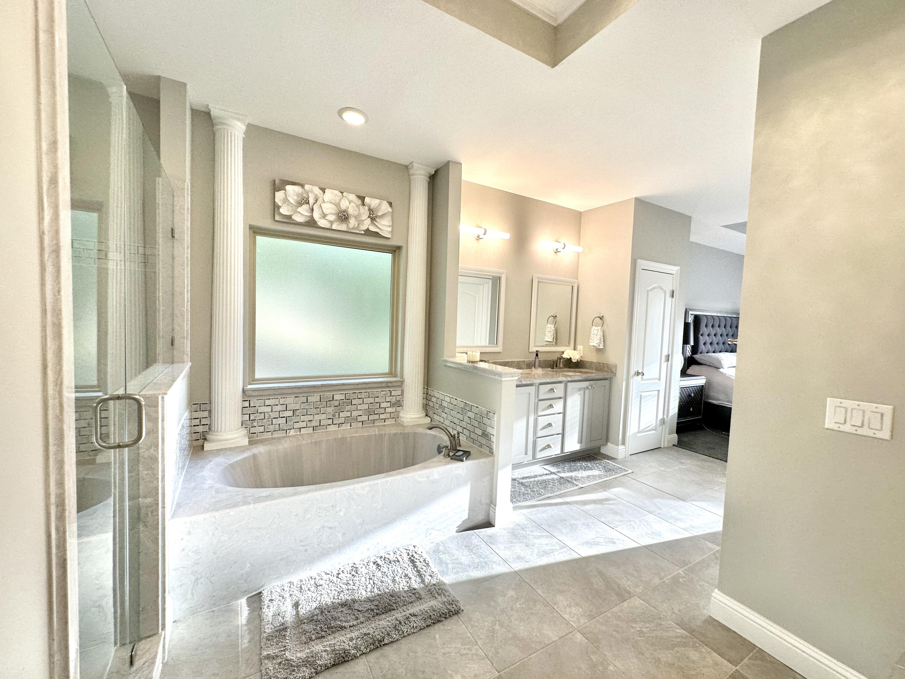 1207 Tallokas Road Crestview, FL 32536 - Photo 29 of 58 a spacious bathroom with a tub sink and mirror