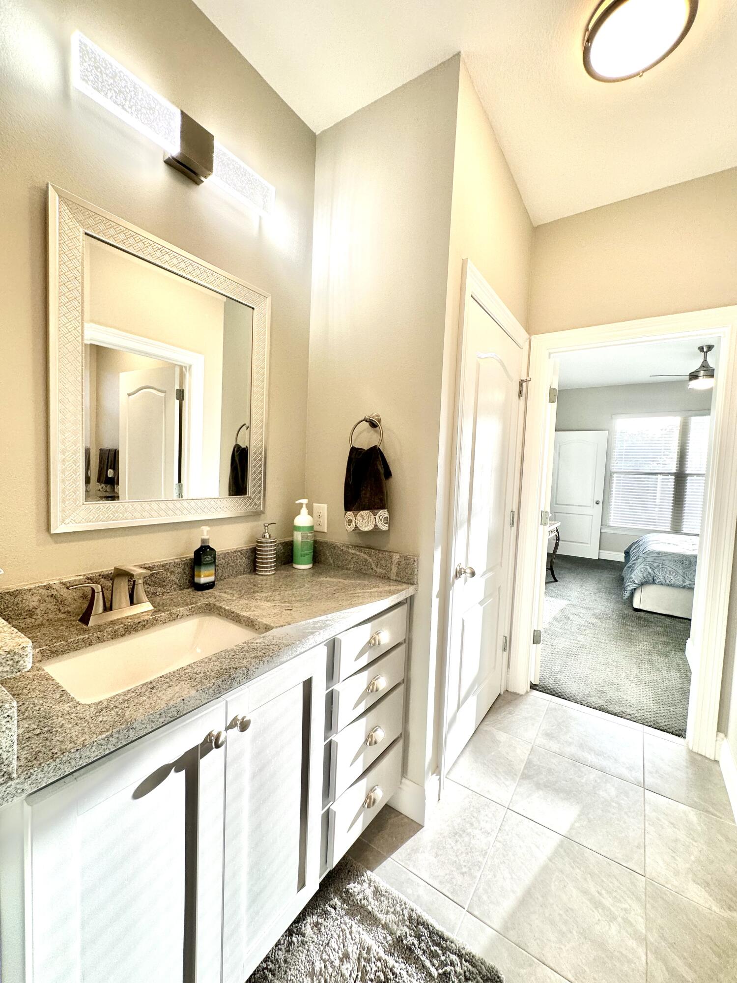 1207 Tallokas Road Crestview, FL 32536 - Photo 40 of 58 a spacious bathroom with a granite countertop sink and a mirror