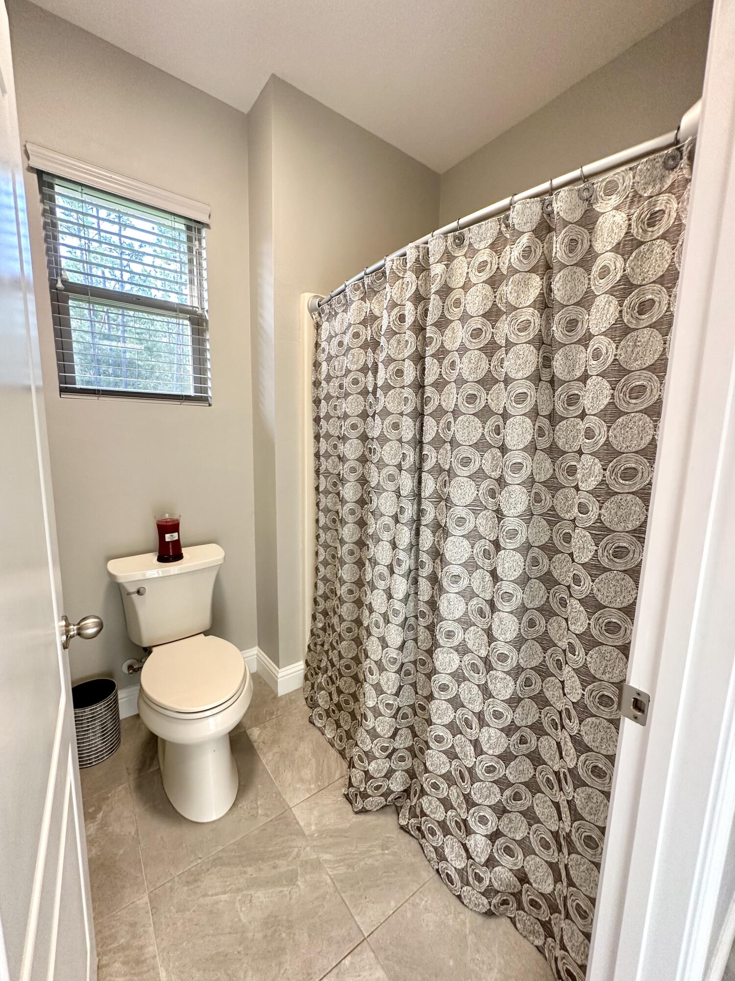 1207 Tallokas Road Crestview, FL 32536 - Photo 42 of 58 a white toilet sitting next to a shower curtain