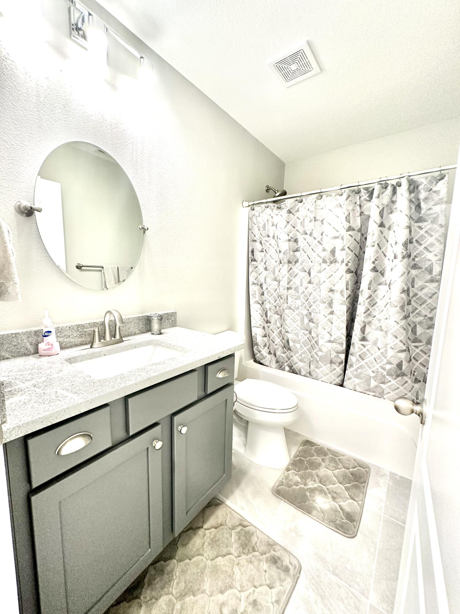 1207 Tallokas Road Crestview, FL 32536 - Photo 56 of 58 a bathroom with a granite countertop sink a toilet and a mirror