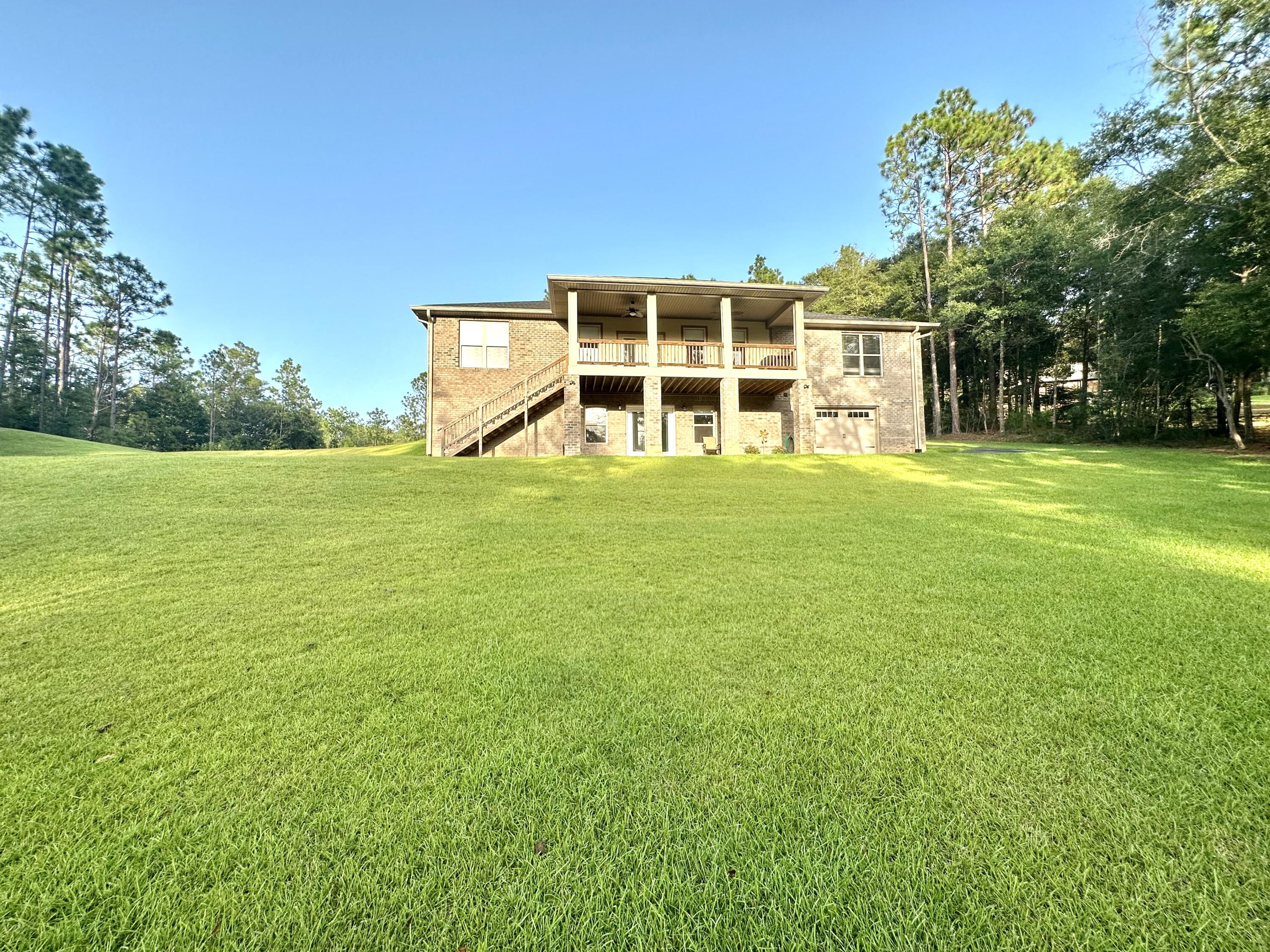1207 Tallokas Road Crestview, FL 32536 - Photo 6 of 58 a view of a big room with a big yard and large trees