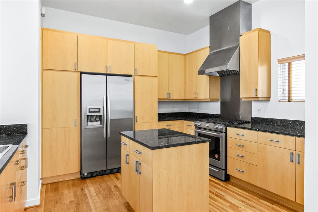 a kitchen with a refrigerator and a sink