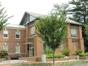 a view of a white house next to a yard