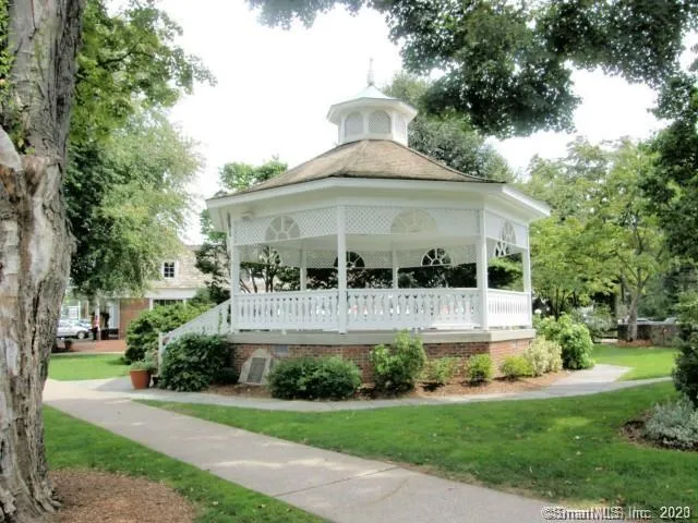 a front view of house with a garden