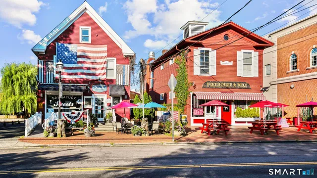 a view of street with shops and cars parked in front of it