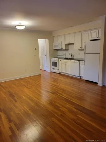 a view of a kitchen with wooden floor
