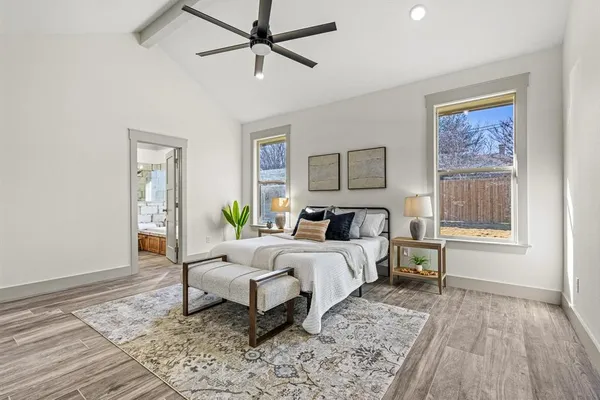 a spacious bedroom with a bed and a window