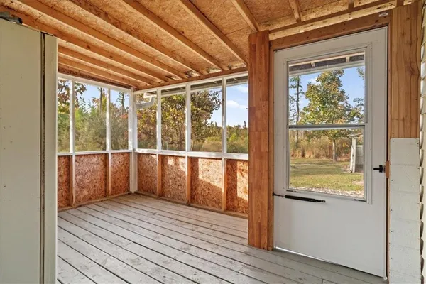 a view of a room with wooden floor and windows