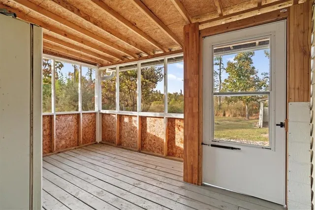 a view of a room with wooden floor and windows