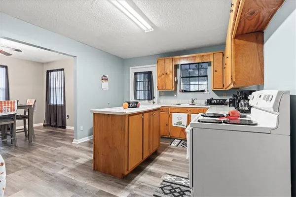 a kitchen that has a sink and a wooden cabinets