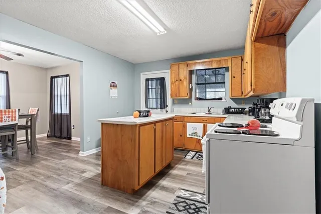 a kitchen that has a sink and a wooden cabinets