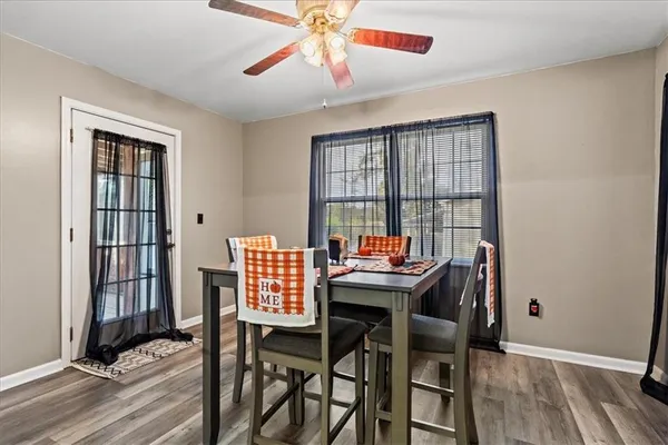 a view of a dining room with furniture and wooden floor