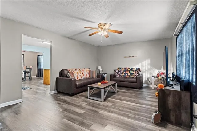 a living room with furniture and a chandelier