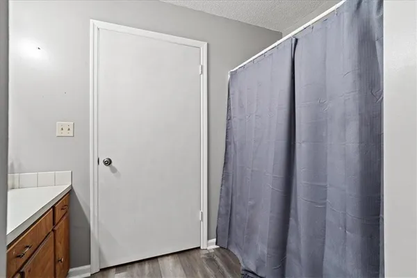 a view of walk in closet with wooden floor