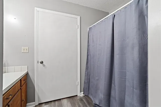 a view of walk in closet with wooden floor