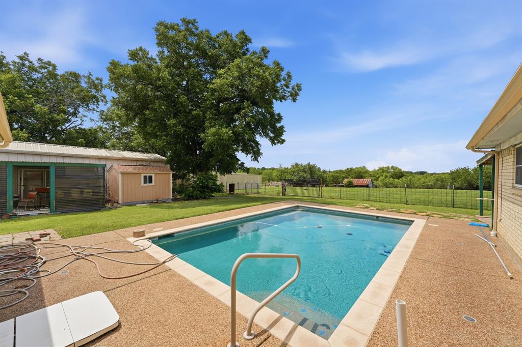 1235 Maxwell Road Haslet, TX 76052 - Photo 30 of 36 Rectangular swimming pool surrounded by a textured concrete patio