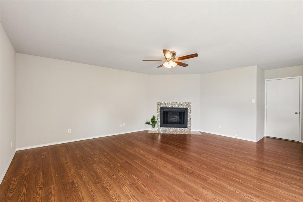 5620 Perrin Street The Colony, TX 75056 - Photo 3 of 31 a view of empty room with wooden floor and fireplace