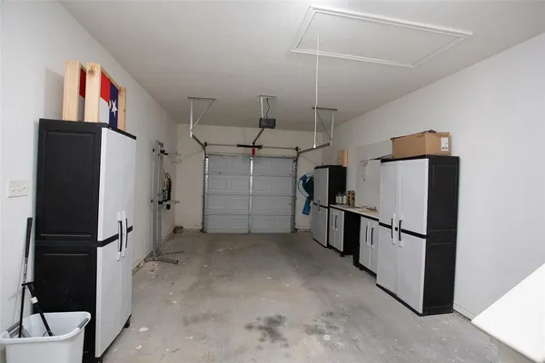 a view of a storage & utility room with refrigerator