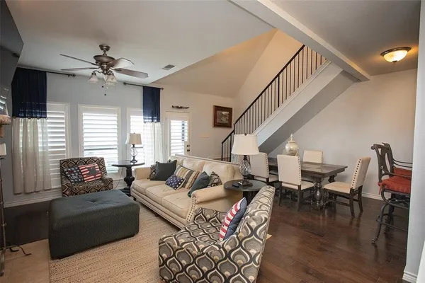 a living room with furniture dining table and a flat screen tv
